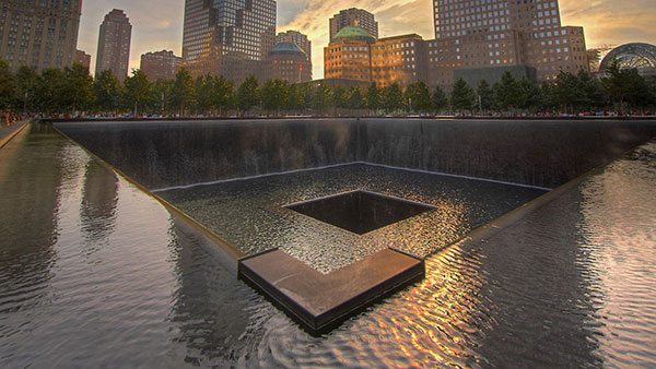 A reflecting pool at the September 11 memorial in New York City at sunrise