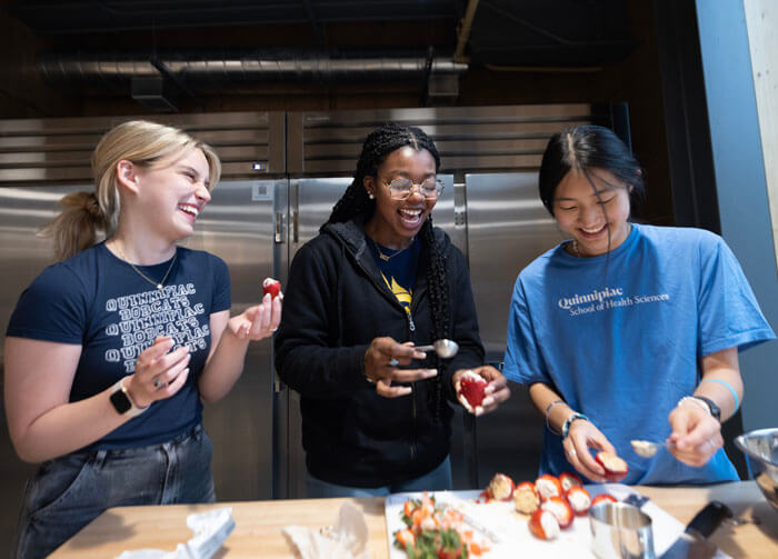 Students cook together in a university kitchen.