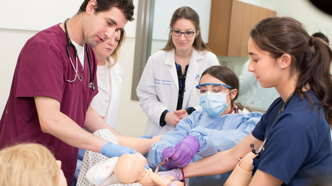 Physician assistant and nursing students deliver a baby during a simulation