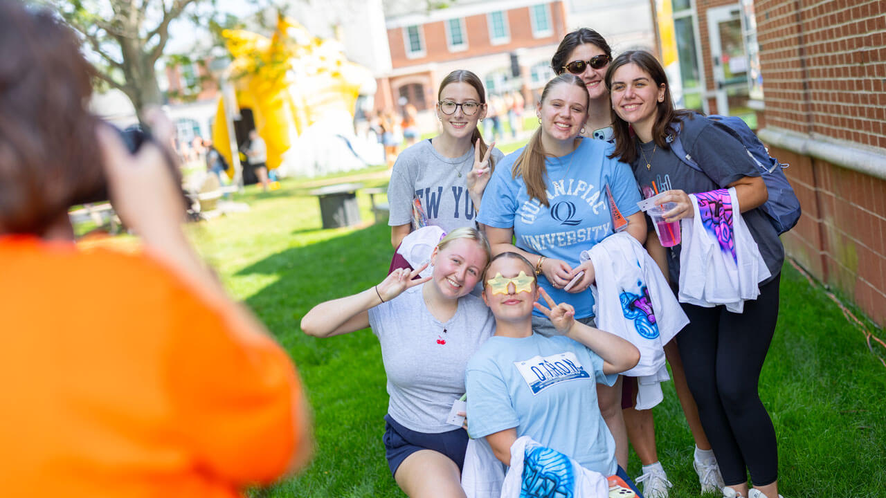Students pose with gifts and trinkets from the various vendors