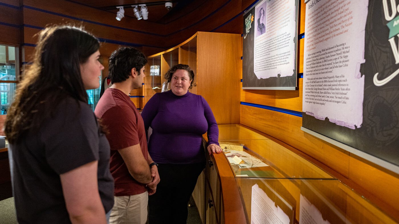 Students discuss items in the Arnold Bernard Library museum with a history professor.