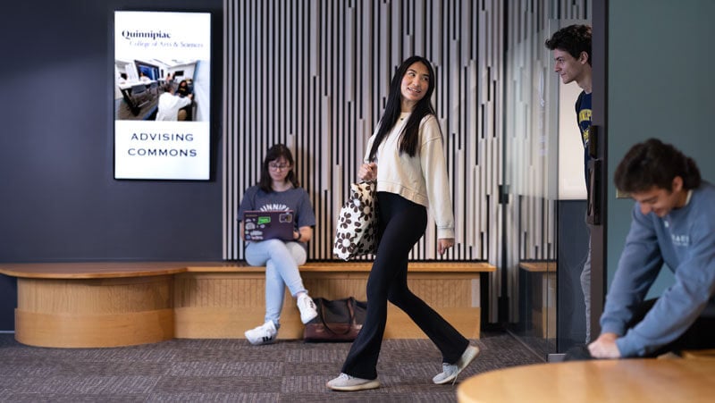 Students walk past the Advising Commons in the College of Arts and Sciences.