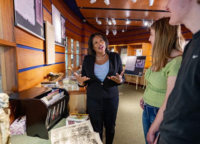 A professor talks with students in the Mount Carmel Campus history museum