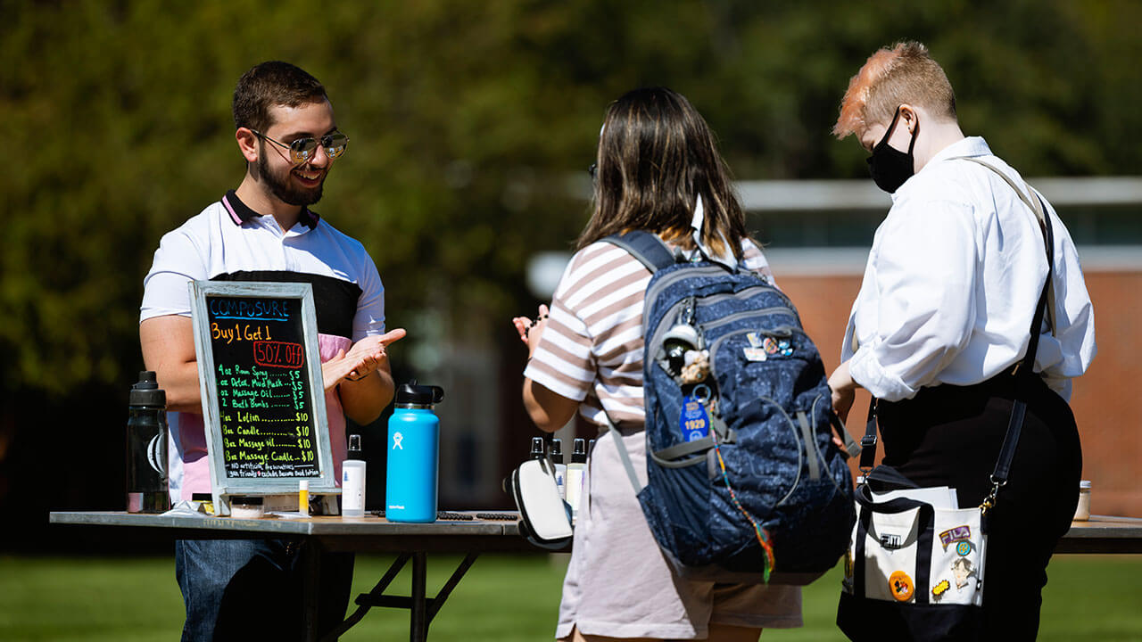 Bryan Zielgelhofer selling his preservative-free lotion on the Quad during a pop-up-shop event