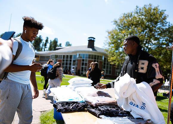 Student showcases his fashion pieces to the community on the Quad