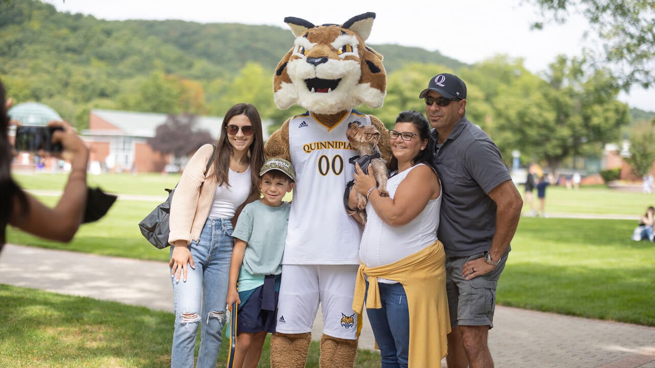 Family with dog takes picture with Boomer