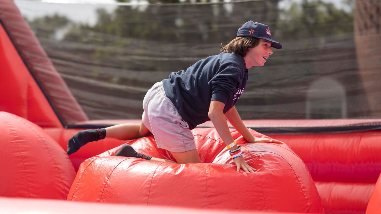 A boy plays in a bouncy house during Bobcat Weekend.