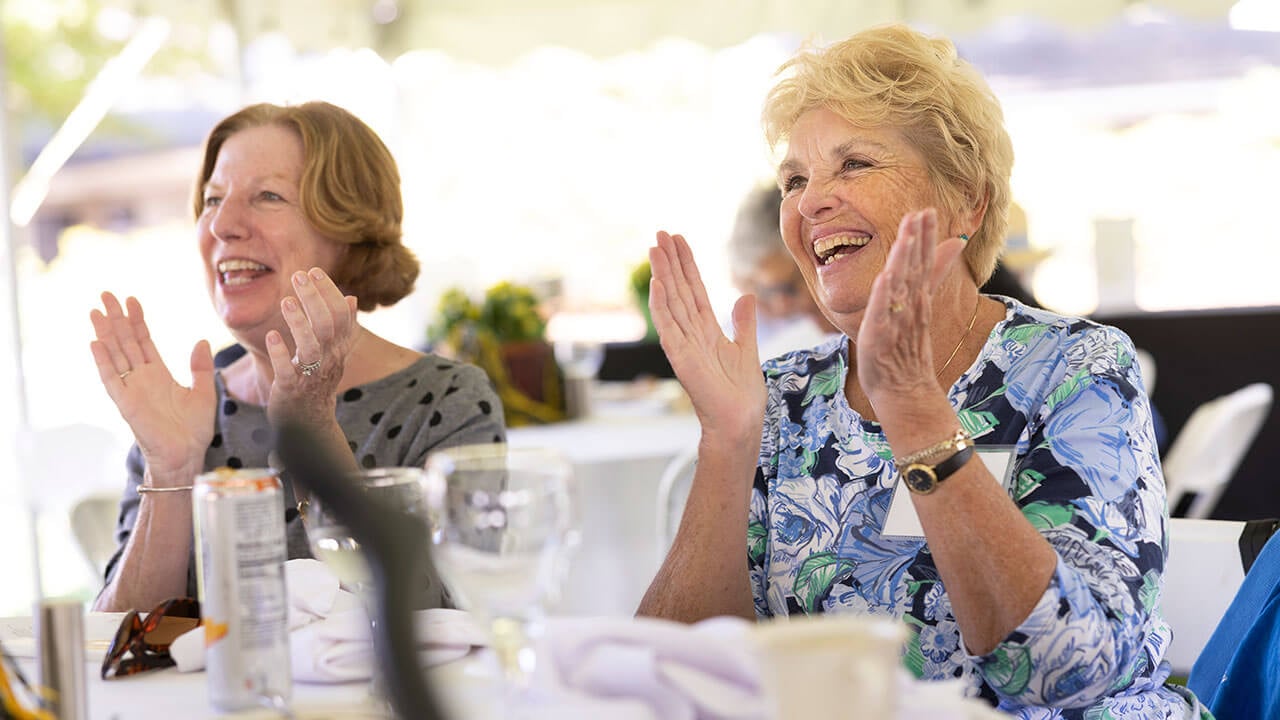 Two women from the Class of 1972 clap during the Golden Bobcat Luncheon