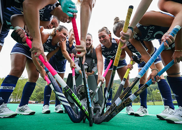 Members of the women's field hockey team play in a game