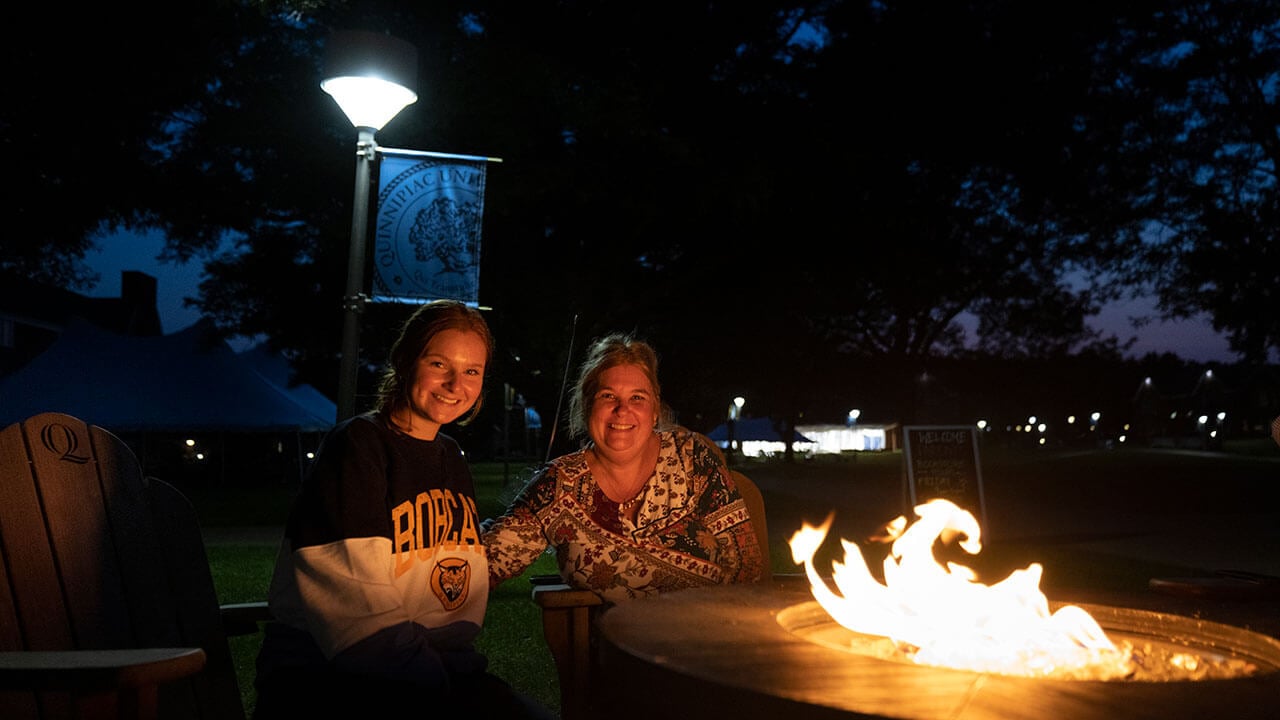 A mother and daughter make s'mores on the Quad's outdoor fire pits
