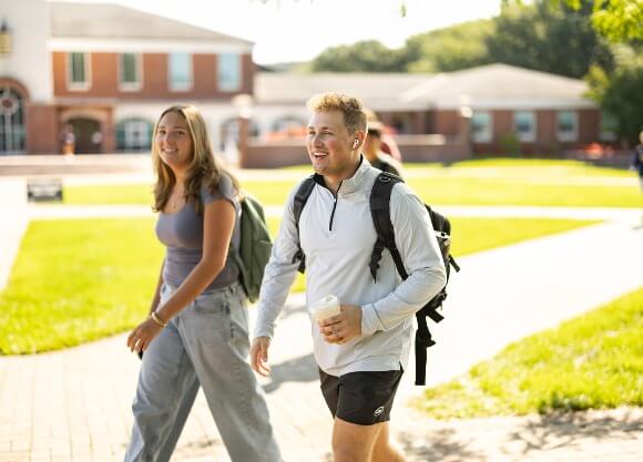 Two students walking across the Quad.