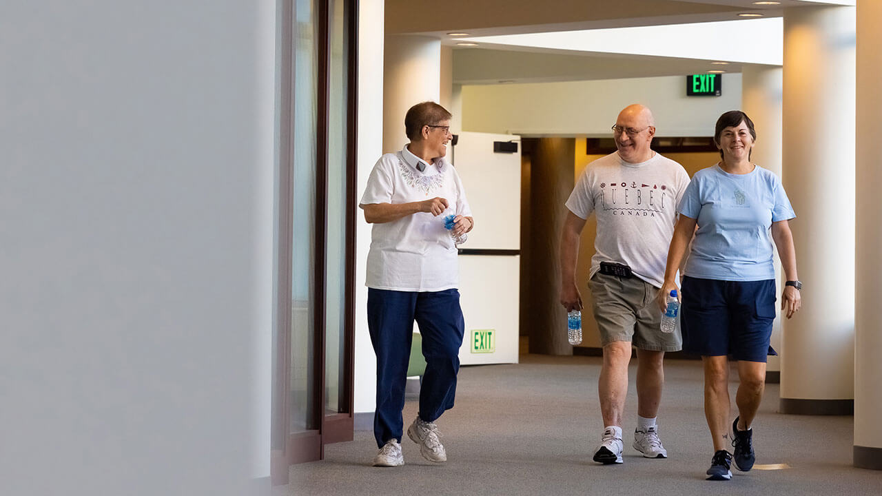 Residents walk the hall of the Center for Medicine, Nursing and Health Sciences building