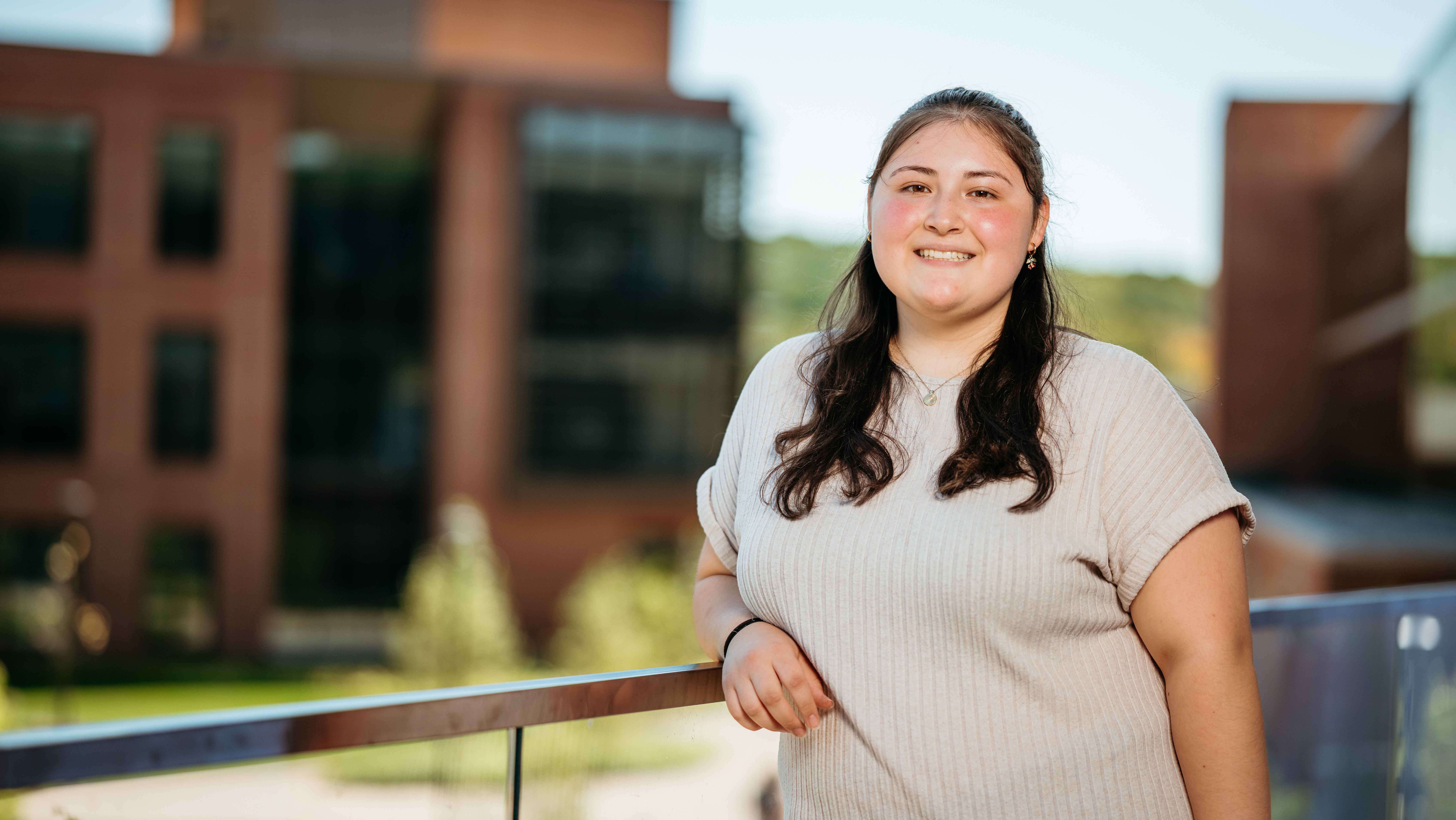 Adelina Chocho, a Sawhney Leadership fellow, poses for a portrait on the balcony of the School of Business on the South Quad.