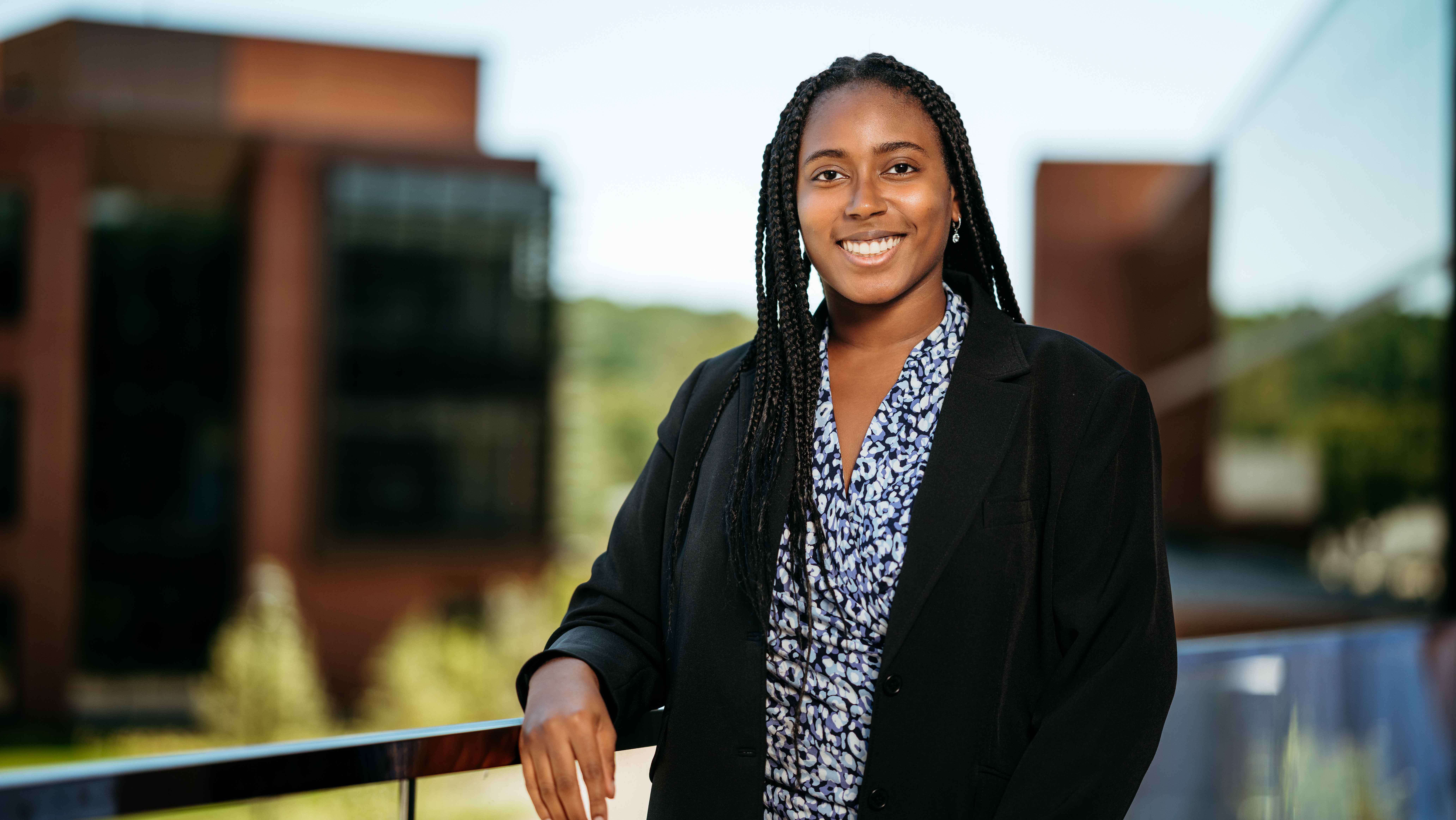 Rachael Allen, a Sawhney Leadership fellow, poses for a portrait on the balcony of the School of Business on the South Quad.