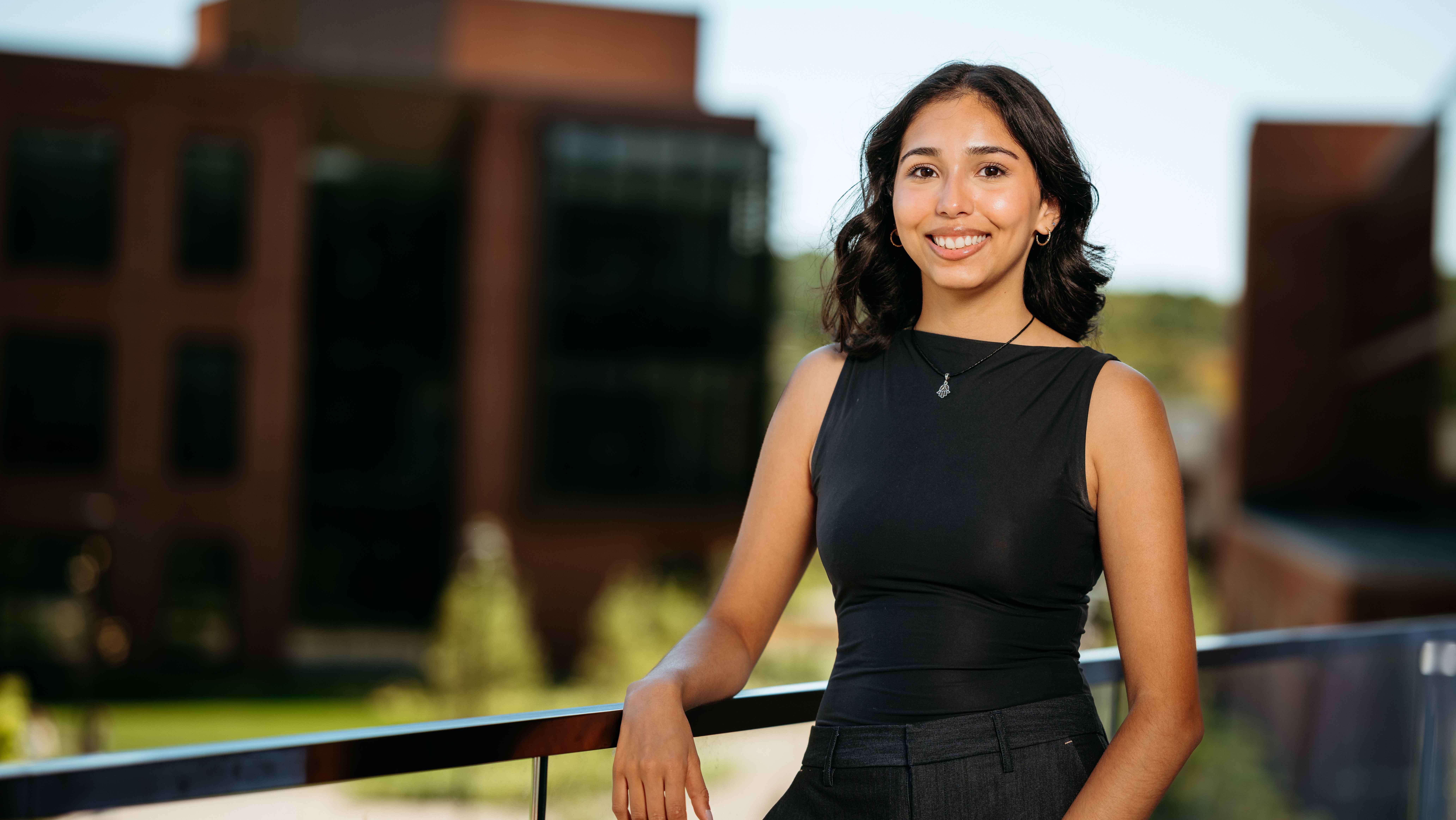 Daina Cleveland, a Sawhney Leadership fellow, poses for a portrait on the balcony of the School of Business on the South Quad.