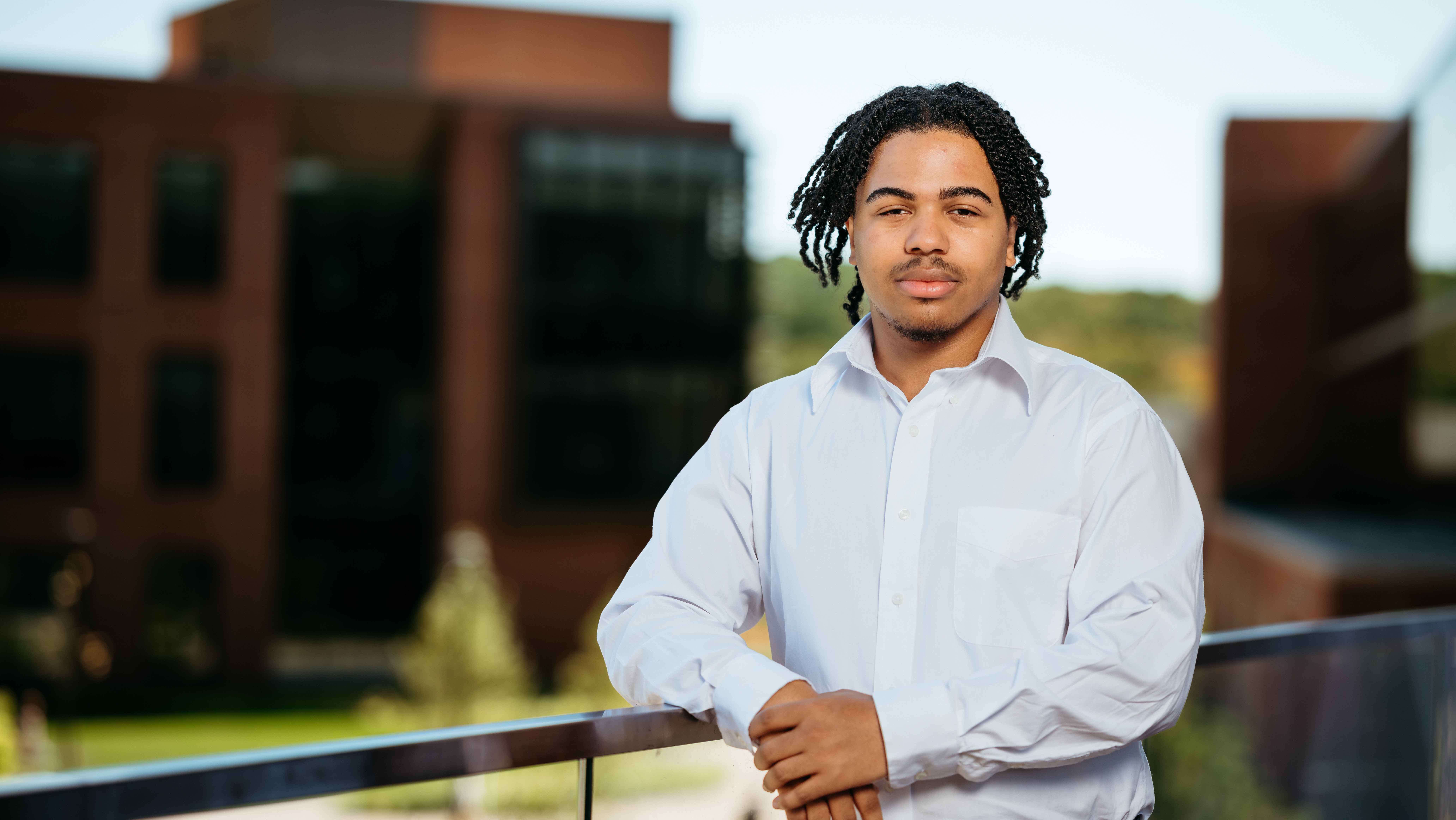 Tysean Price, a Sawhney Leadership fellow, poses for a portrait on the balcony of the School of Business on the South Quad.