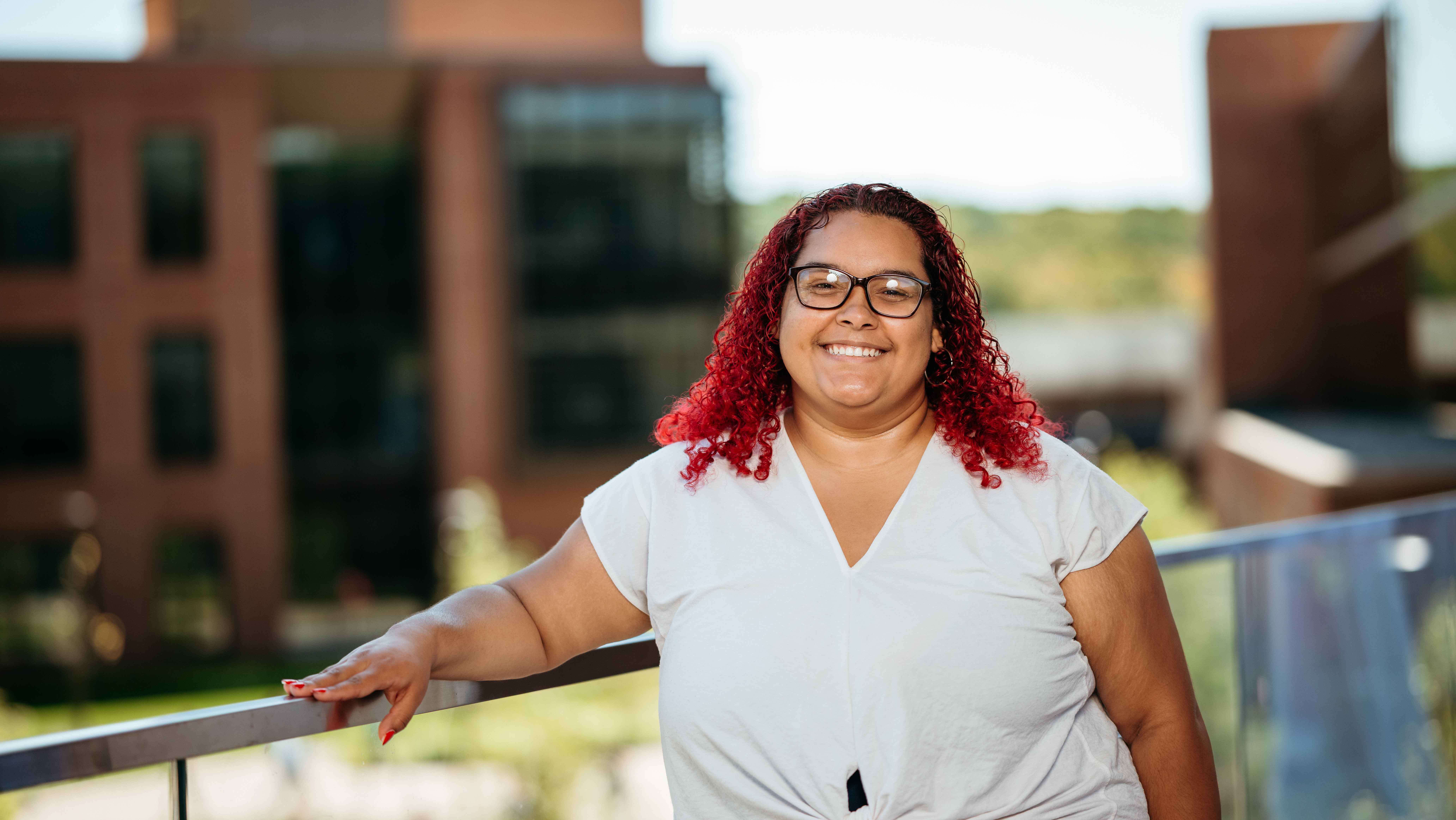 Arielys Medina, a Sawhney Leadership fellow, poses for a portrait on the balcony of the School of Business on the South Quad.