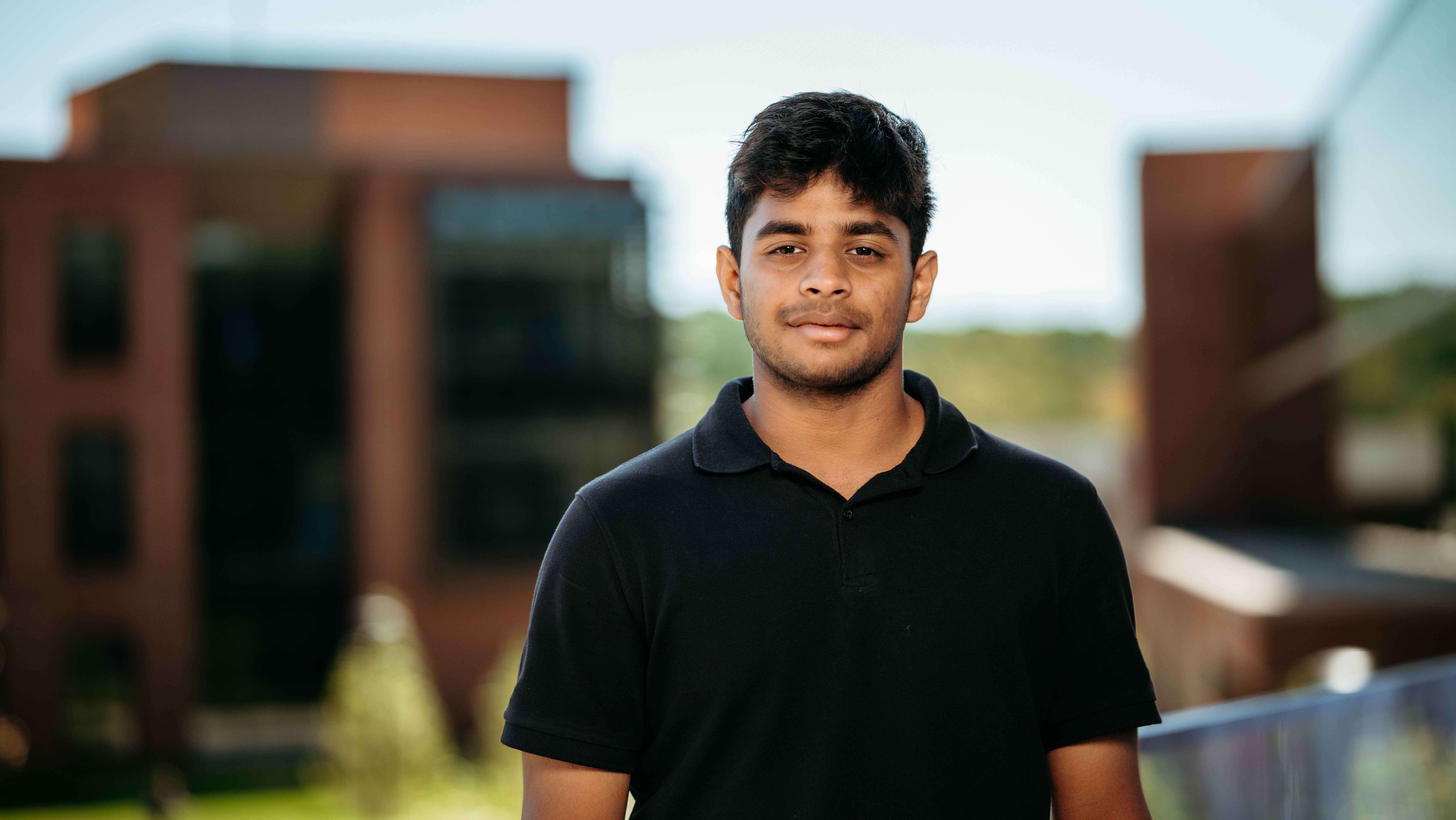 Gaurav Mootha, a Sawhney Leadership fellow, poses for a portrait on the balcony of the School of Business on the South Quad.