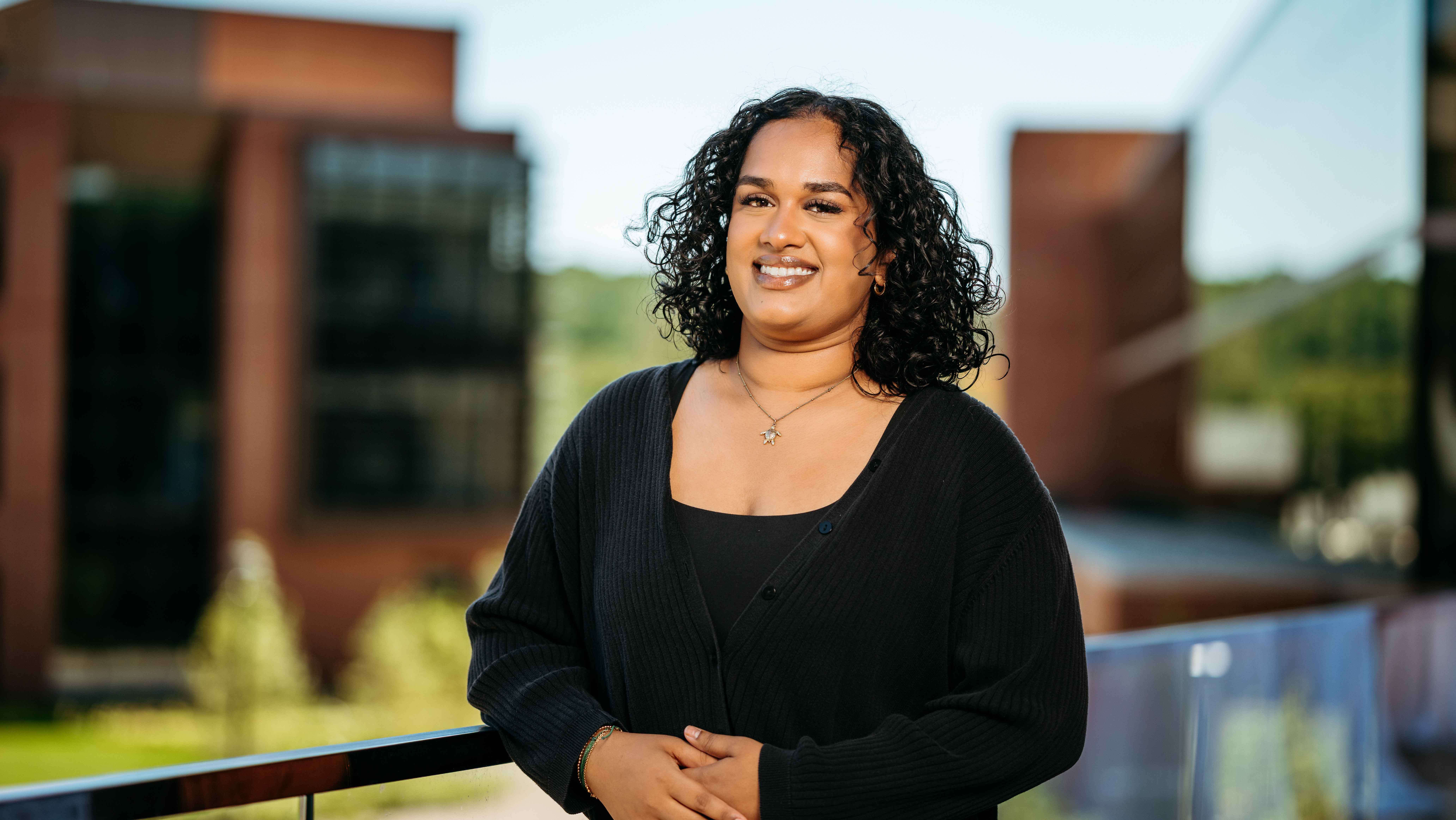 Jessica Theodore, a Sawhney Leadership fellow, poses for a portrait on the balcony of the School of Business on the South Quad.