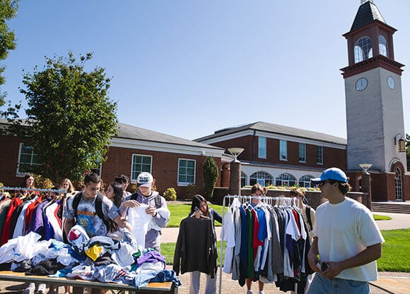 Students shop at a clothing business on the quad.