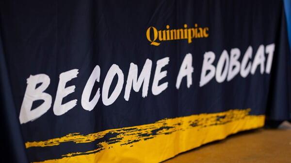 Become a Bobcat sign at a Quinnipiac undergrad admissions event