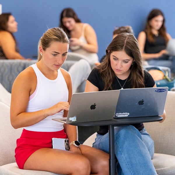 Students study together in the lobby of the School of Business