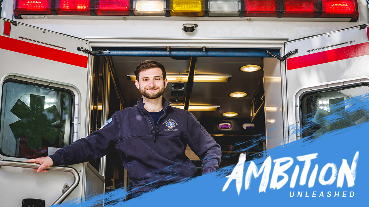 Ambition Unleashed: Charles Dunn stands at the back of an ambulance