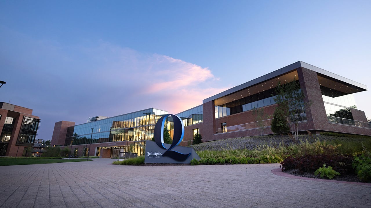 The School of Business with a dark blue evening sky