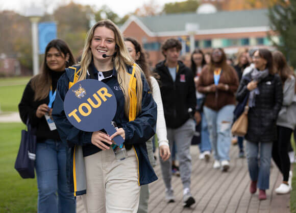 Tour guide leading students on campus