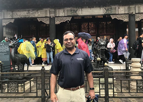 Professor Mohammad Elahee in front of a Chinese building during a personal research trip.