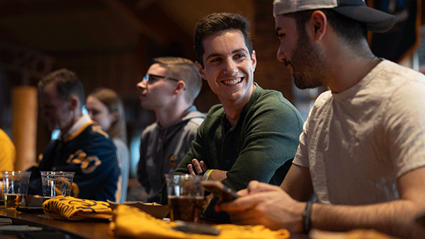 Students socializing at On the Rocks Pub on York Hill's Campus
