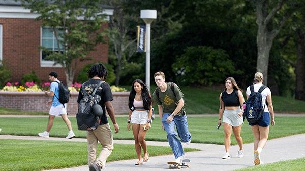 Students walking and skateboarding on the quad