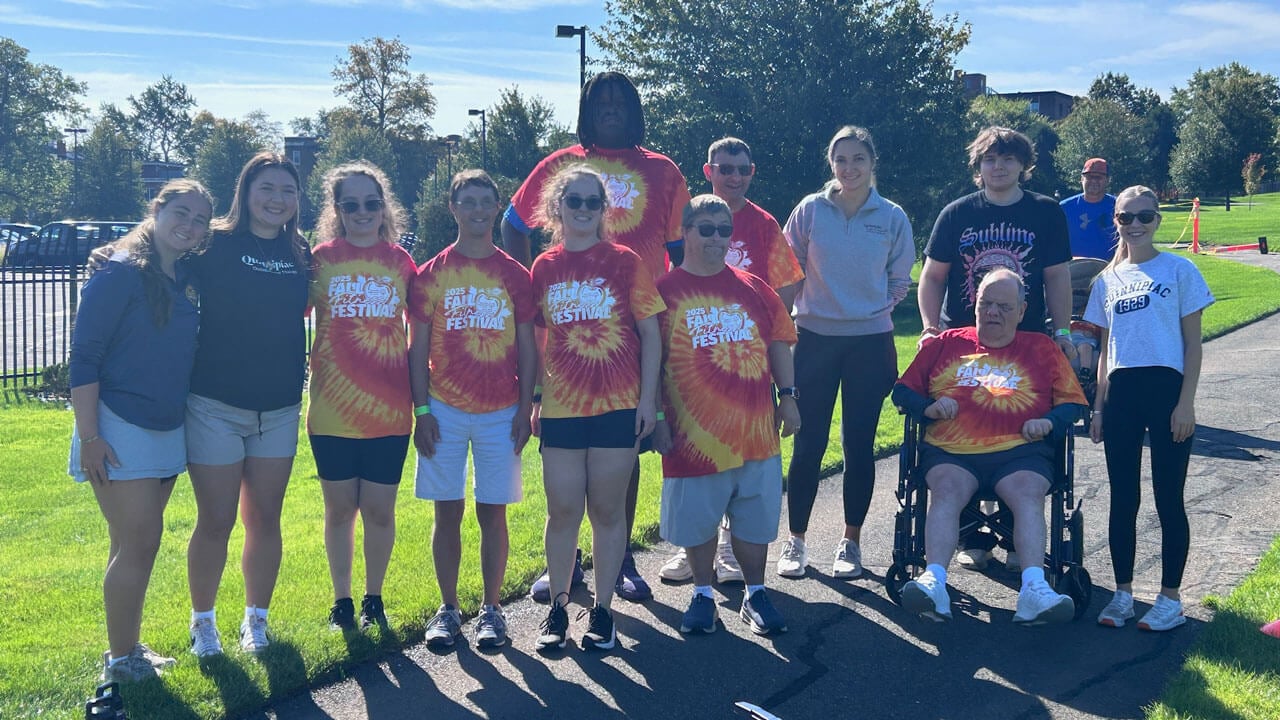 A group of athletes in matching shirts pose for a picture.