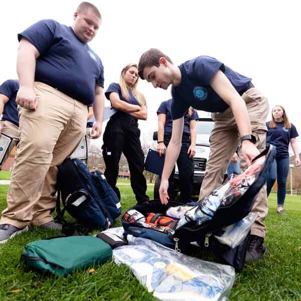 Charles Dunn and other student EMS members work with various lifesaving equipment
