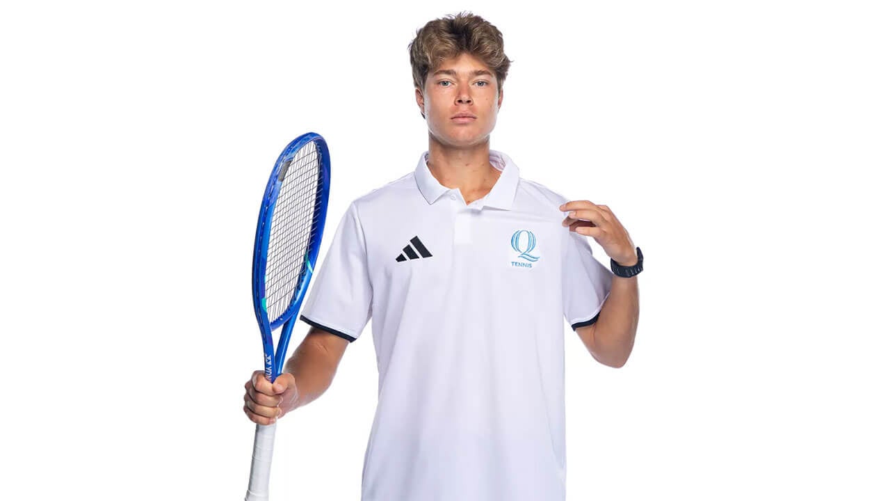 Tennis player poses with their racket.