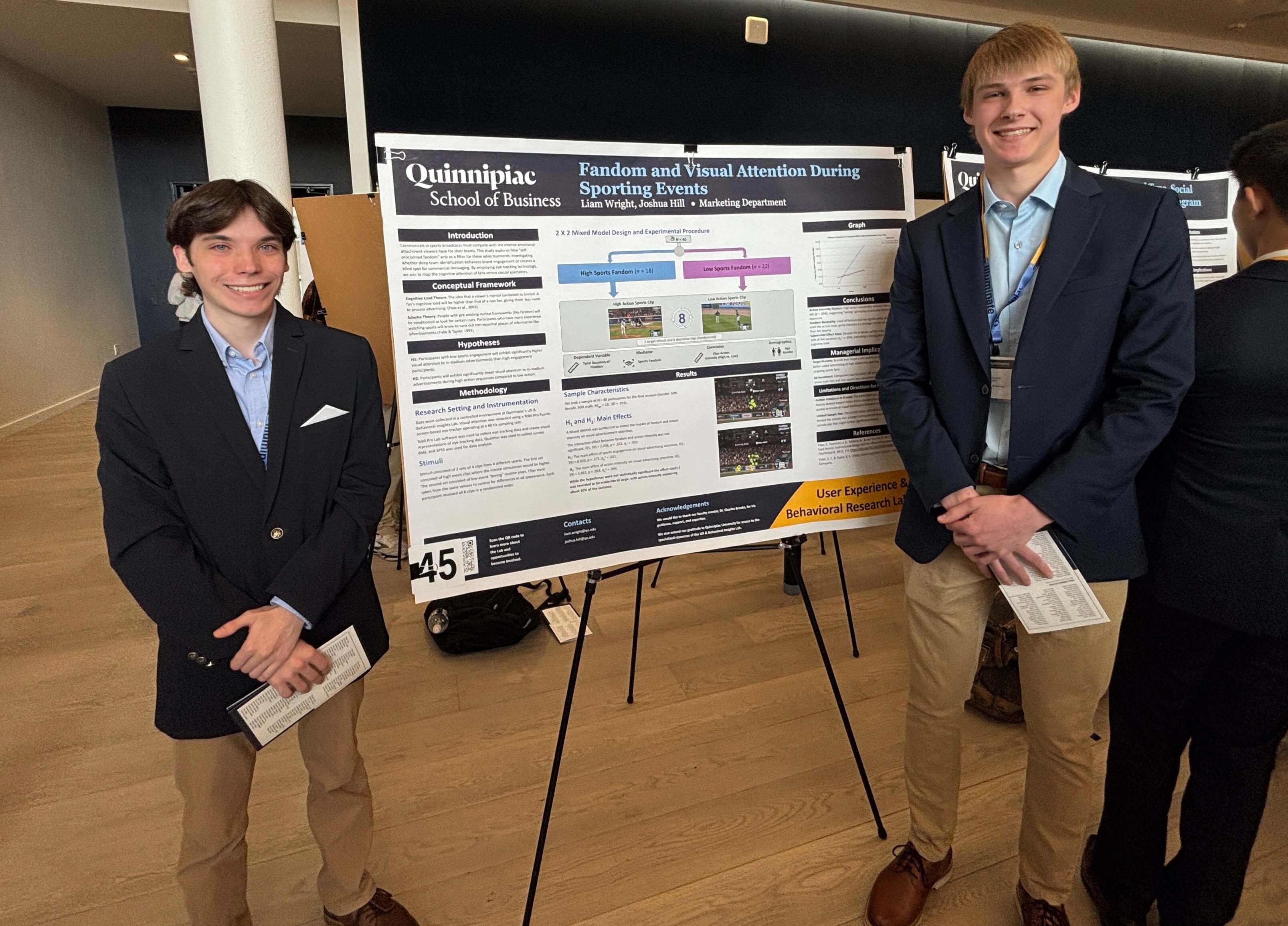 Students Liam Wright and Josh Hill stand in front of their poster for this research project