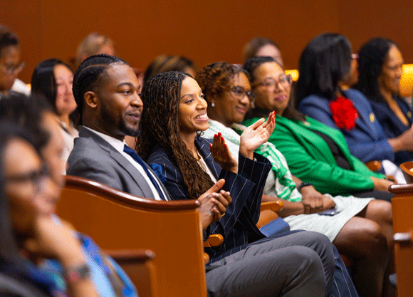 Crowd of individuals watching the panelist talk at the School of Law symposium