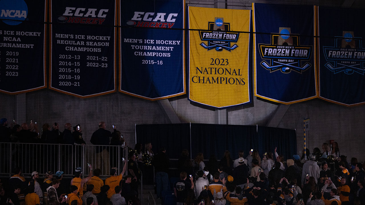 The men's ice hockey national championship banner rises.