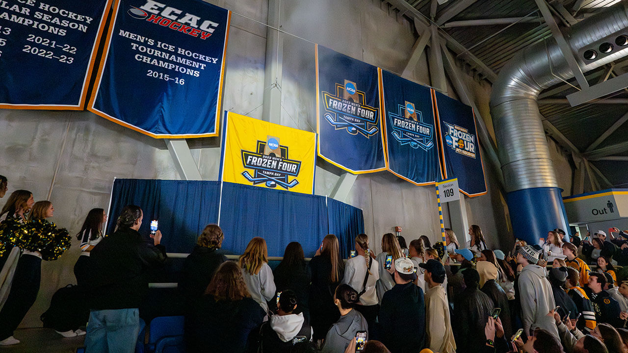 The national championship hockey banner getting raised in the arena