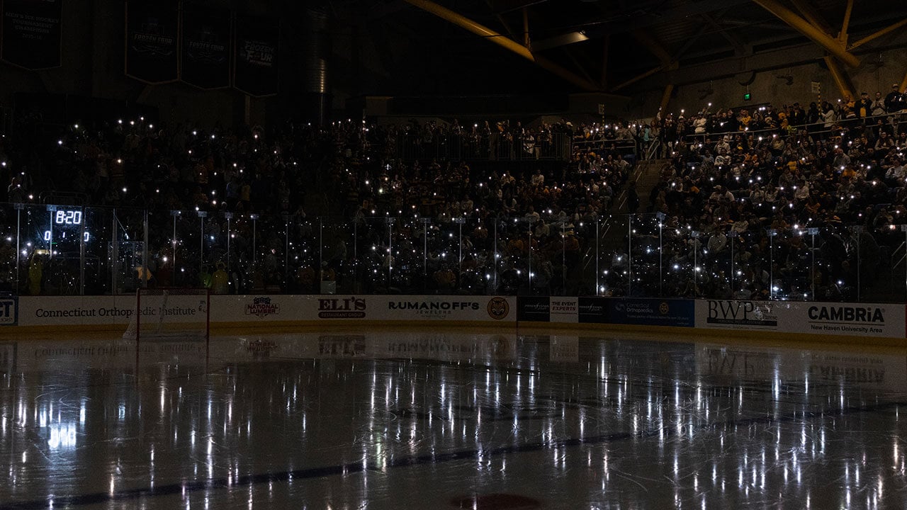 Fans sway their flashlights in the M&T Bank Arena