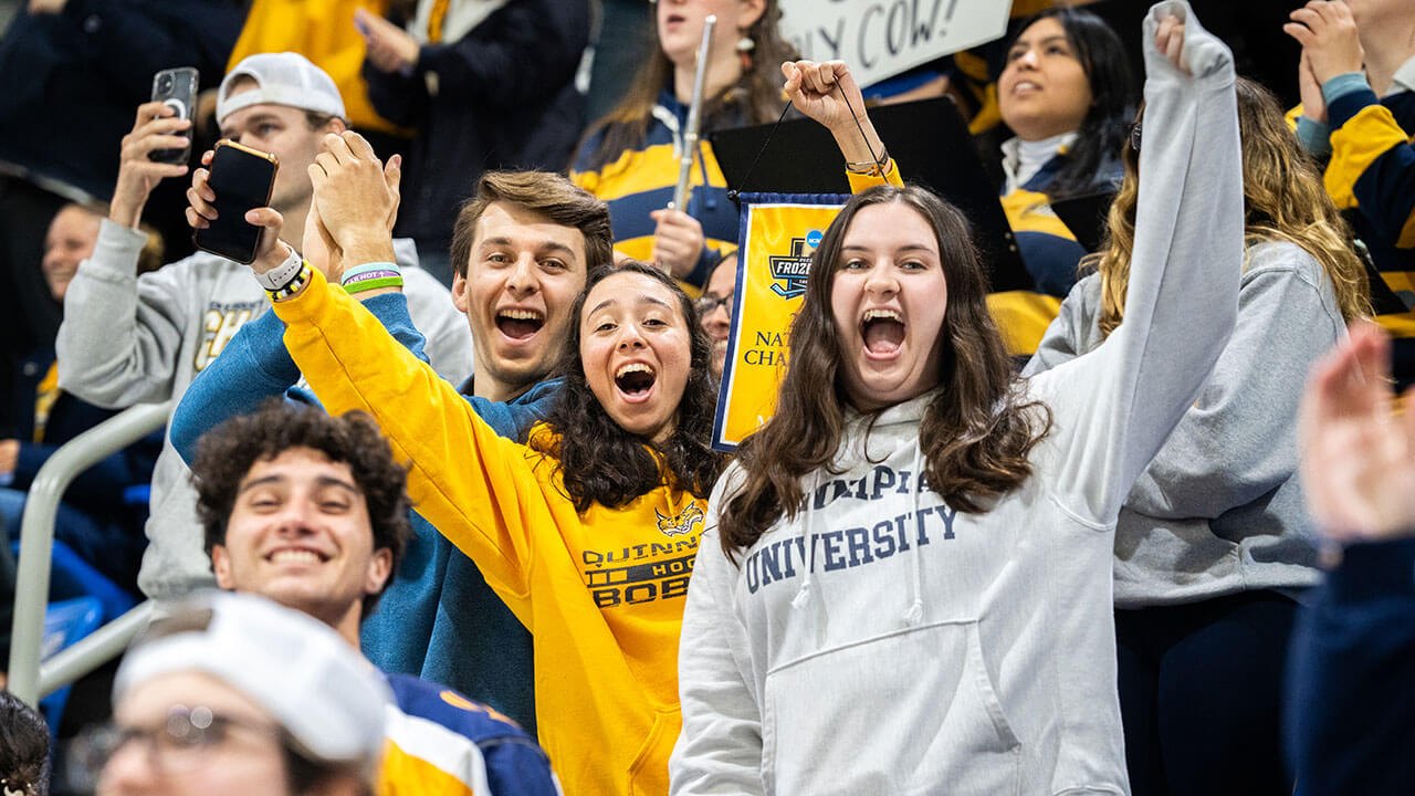 Fans dance and cheer for the men's ice hockey team