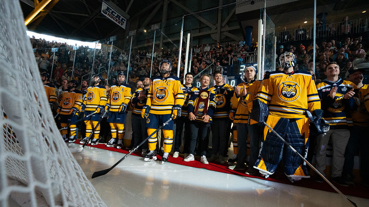 The Quinnipiac men's ice hockey team stands on the ice