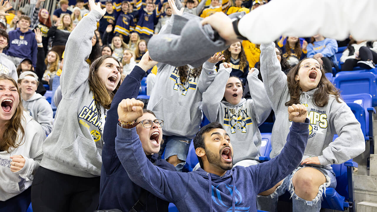 Students cheer during a sweatshirt giveaway
