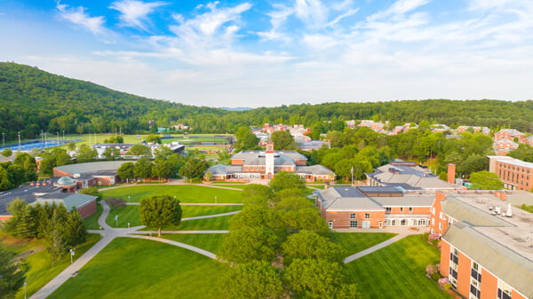 Aerial view of Mount Carmel Campus quad and several buildings and residence halls on a blue sky day