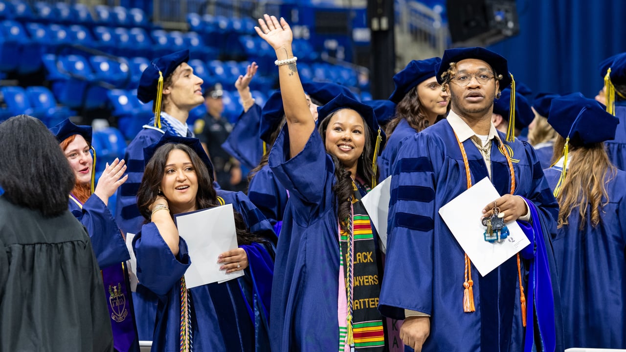 Graduate waves to loved ones