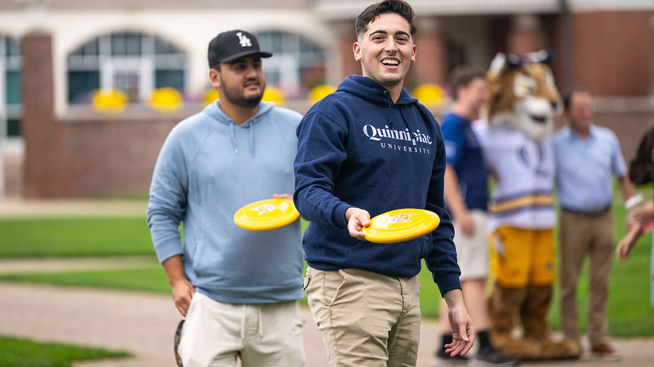 Students hold frisbees playing KanJam