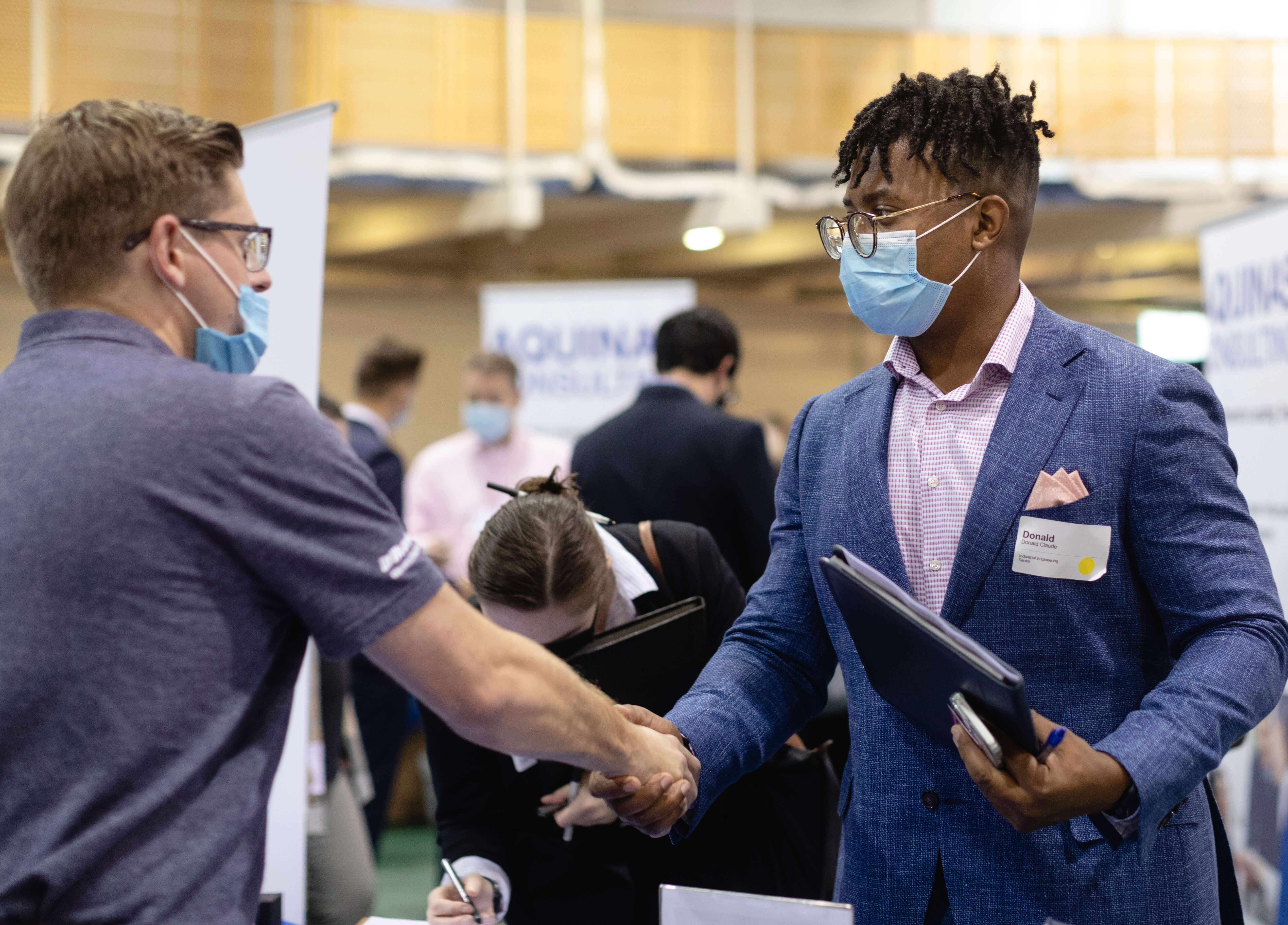 Two people shake hands at the career fair