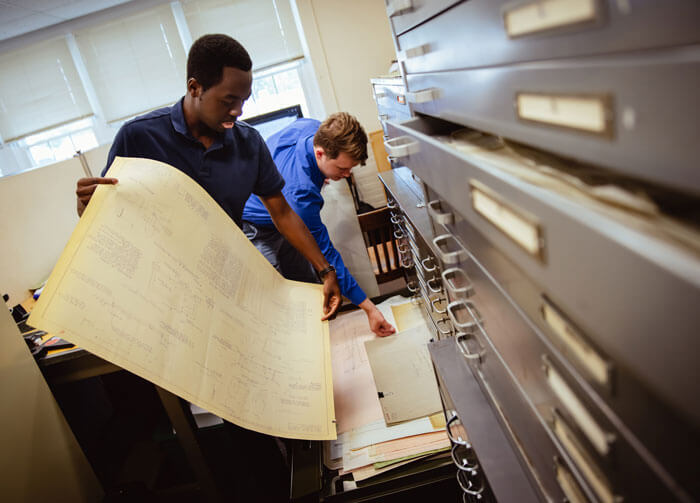Students work in a filing cabinet as part of the public service project