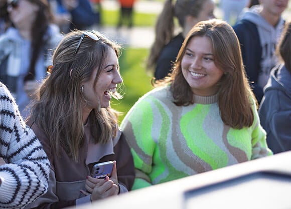 Students laugh and celebrate Fall Fest on the Quad.