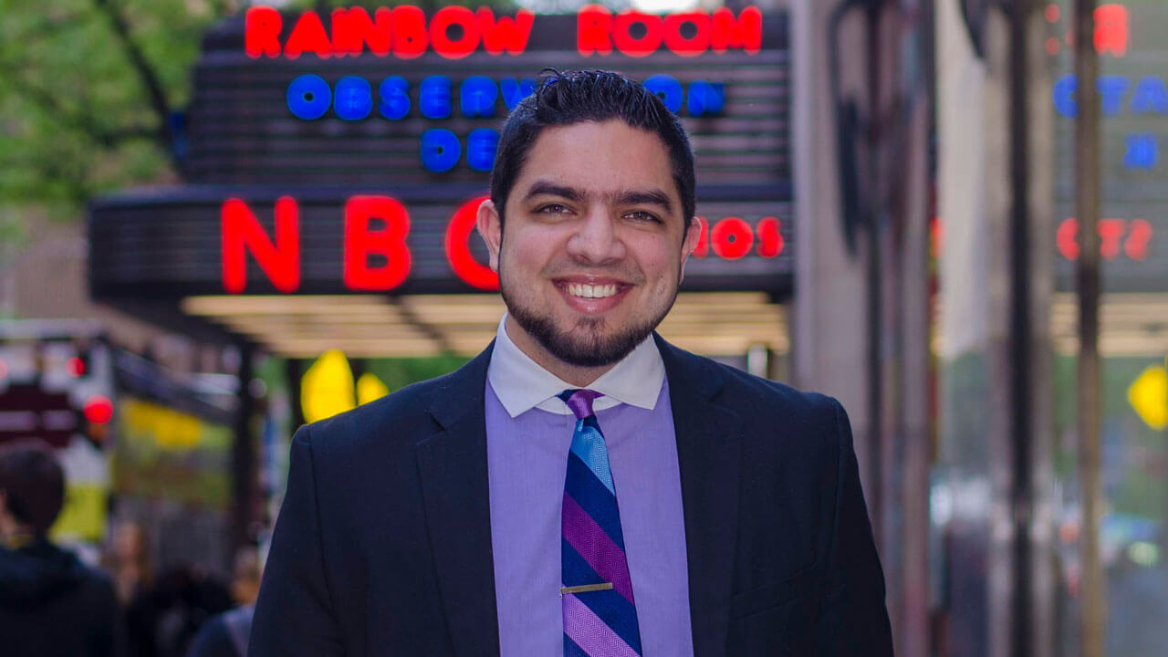 Marcus Harun '14, MBA '15, stands in front of NBC News